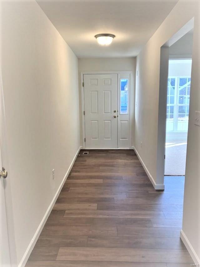 entryway with dark hardwood / wood-style floors