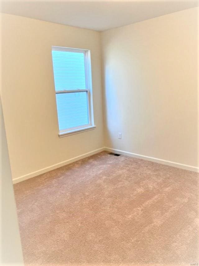 spare room with light colored carpet