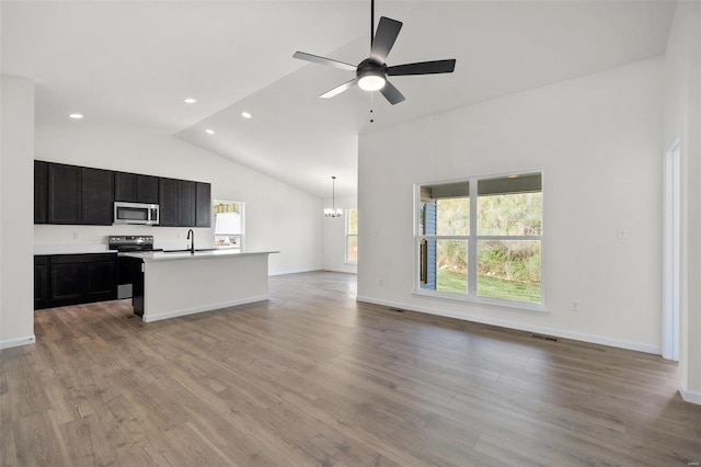 kitchen with ceiling fan with notable chandelier, light hardwood / wood-style flooring, stainless steel appliances, sink, and hanging light fixtures