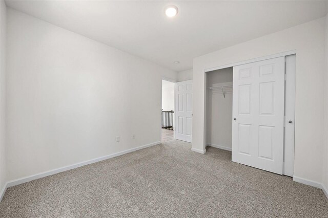 unfurnished bedroom with carpet and a closet