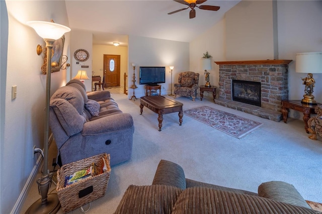 carpeted living room with ceiling fan and vaulted ceiling