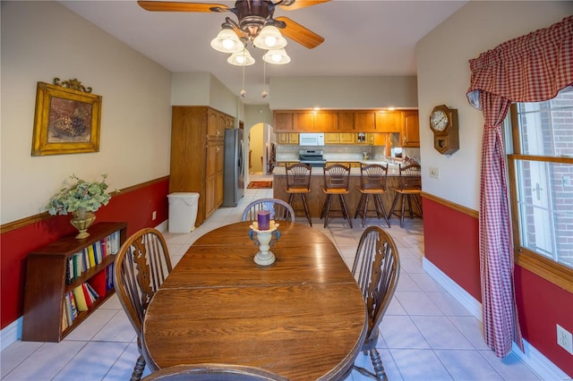 tiled dining area featuring ceiling fan