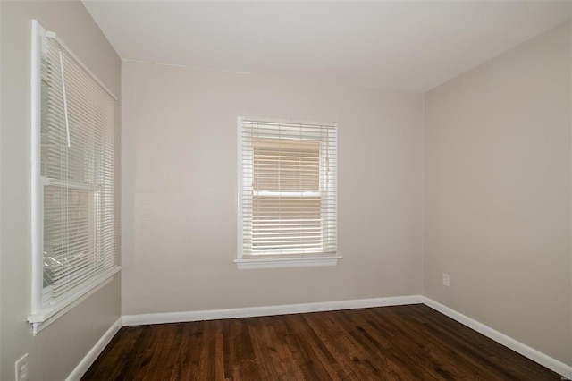 spare room featuring dark wood-type flooring