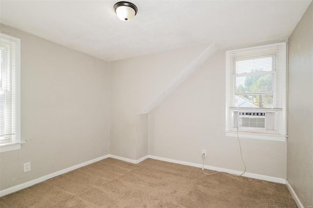 bonus room with cooling unit and light colored carpet