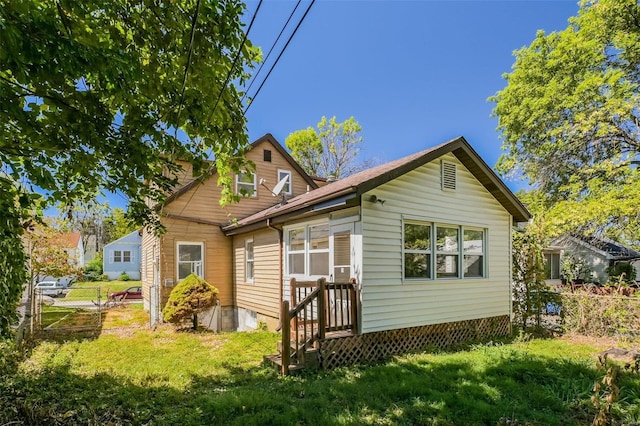 back of property featuring a lawn