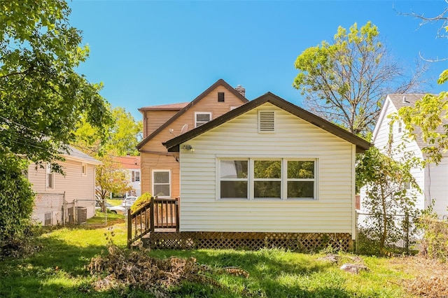 rear view of property featuring a yard