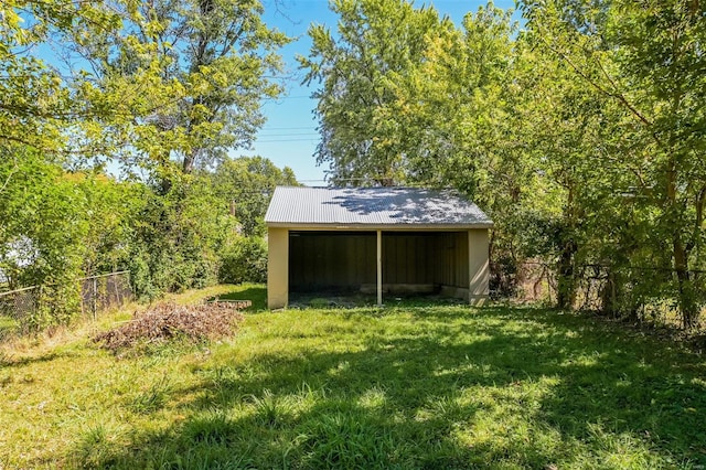 view of outbuilding with a yard