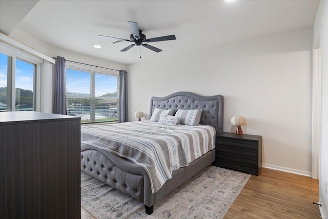 bedroom with hardwood / wood-style flooring and ceiling fan