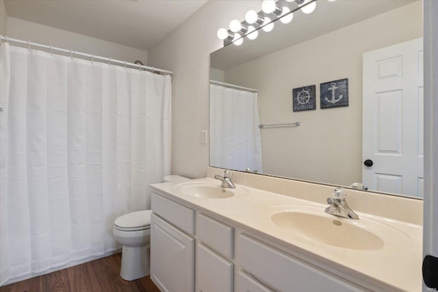 bathroom featuring vanity, toilet, a shower with curtain, and hardwood / wood-style flooring