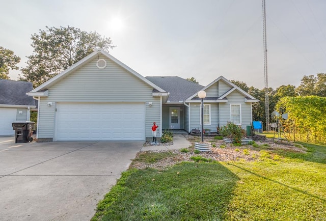 ranch-style home with a garage and a front lawn