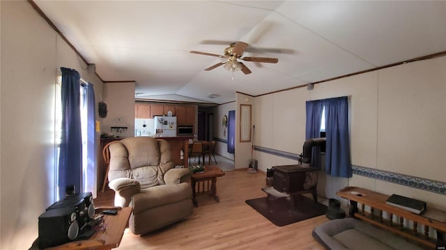 living room featuring light wood-type flooring, vaulted ceiling, and ceiling fan