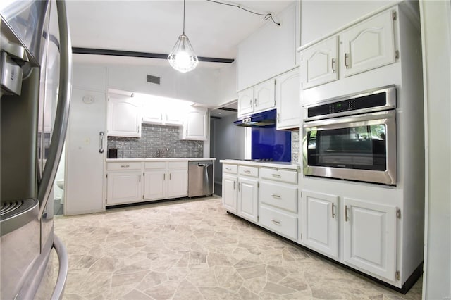 kitchen with lofted ceiling, decorative light fixtures, white cabinetry, stainless steel appliances, and tasteful backsplash