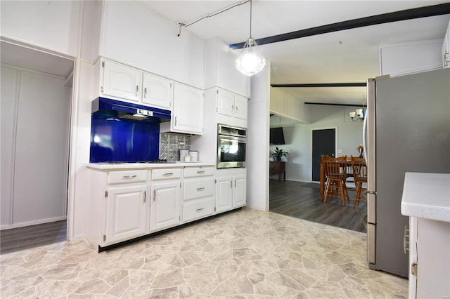 kitchen with pendant lighting, appliances with stainless steel finishes, white cabinetry, tasteful backsplash, and a notable chandelier