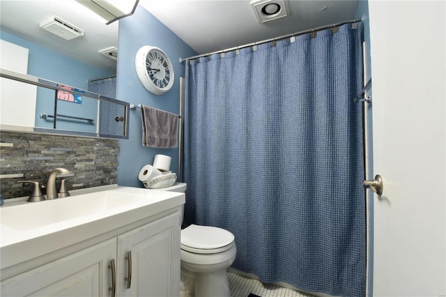 bathroom with toilet, vanity, and decorative backsplash