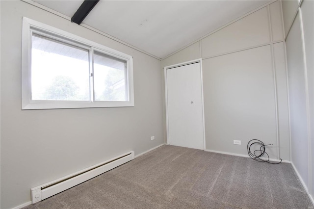 unfurnished bedroom featuring lofted ceiling, a baseboard heating unit, and carpet