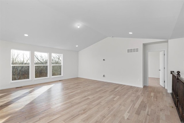 additional living space with vaulted ceiling and light hardwood / wood-style floors