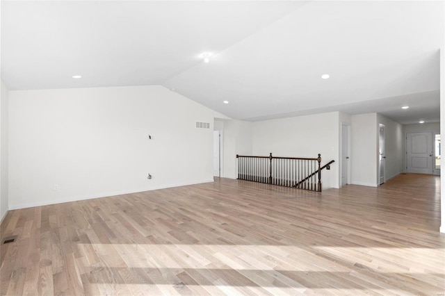 bonus room with vaulted ceiling and light hardwood / wood-style flooring