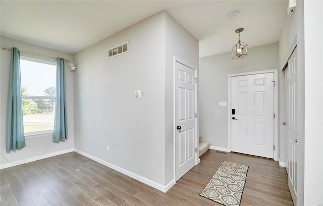 foyer entrance featuring a notable chandelier and hardwood / wood-style floors