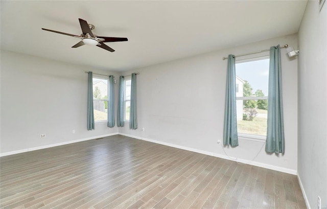 unfurnished room with ceiling fan and light wood-type flooring