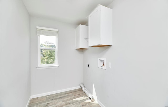 clothes washing area with washer hookup, light hardwood / wood-style flooring, cabinets, and electric dryer hookup