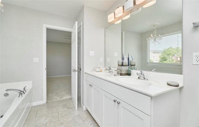 bathroom with a bath, tile patterned flooring, an inviting chandelier, and vanity