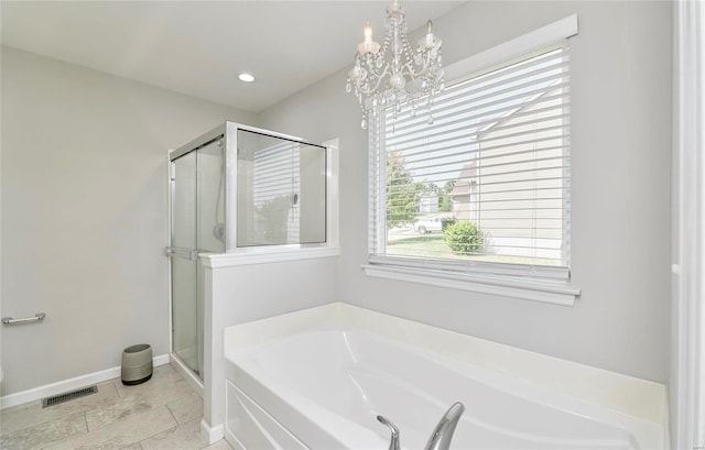 bathroom with independent shower and bath, a notable chandelier, and tile patterned flooring