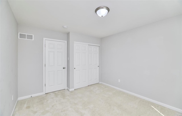 unfurnished bedroom with light colored carpet