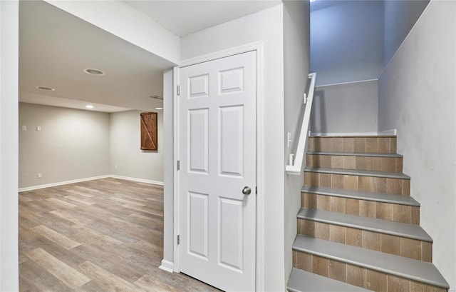 stairs featuring wood-type flooring