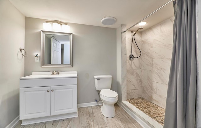 bathroom featuring vanity, toilet, hardwood / wood-style floors, and walk in shower