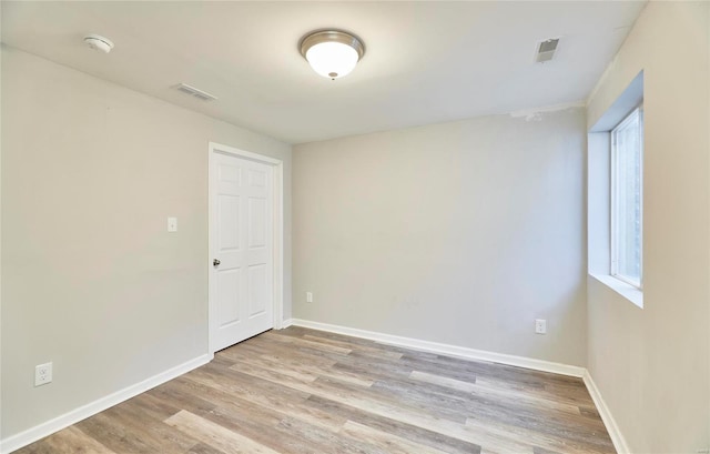 spare room featuring light wood-type flooring