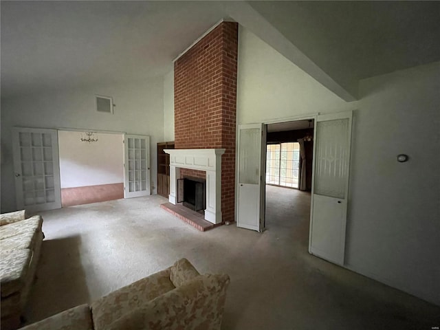 unfurnished living room featuring carpet, high vaulted ceiling, and a brick fireplace