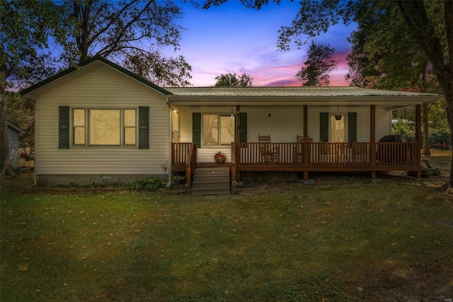 view of front of property featuring a yard and a porch