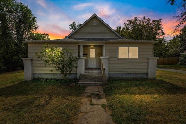 bungalow-style home featuring a front yard