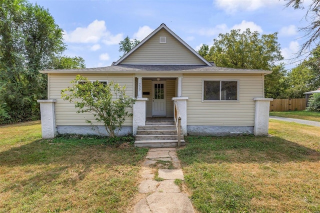 bungalow-style home with a front lawn