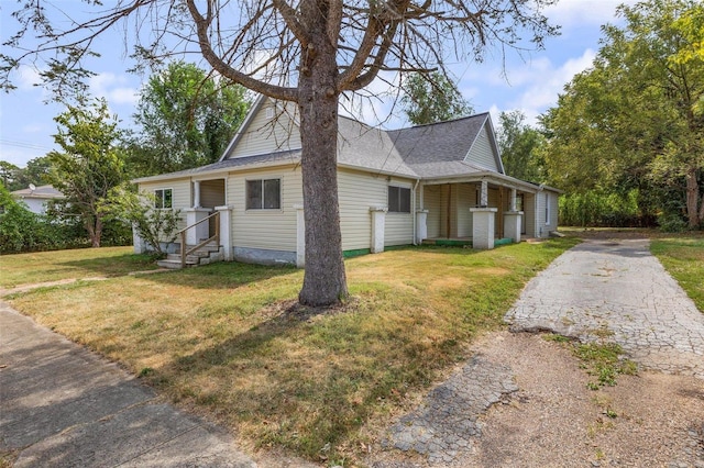 view of home's exterior with a lawn, driveway, and roof with shingles