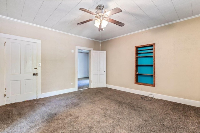 carpeted empty room featuring a ceiling fan, ornamental molding, and baseboards