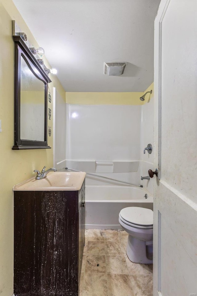 bathroom with washtub / shower combination, vanity, toilet, and visible vents