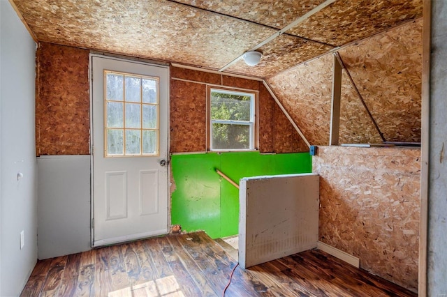 interior space featuring wood finished floors and lofted ceiling