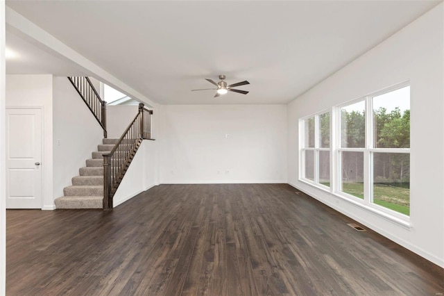 unfurnished living room featuring ceiling fan and dark hardwood / wood-style floors