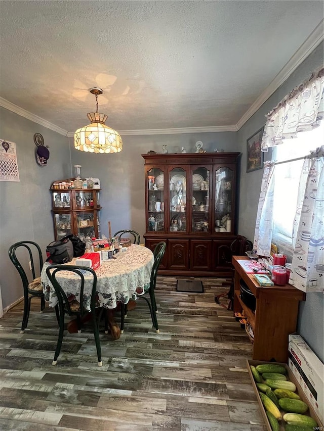 dining space featuring crown molding, dark hardwood / wood-style flooring, and a textured ceiling