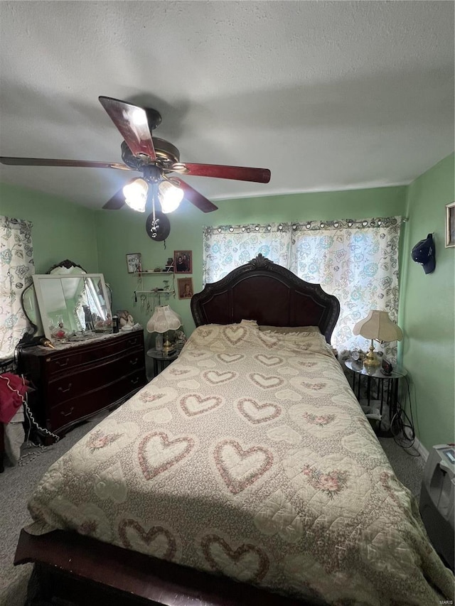 carpeted bedroom featuring a textured ceiling and ceiling fan