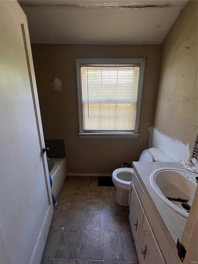 bathroom featuring vanity, toilet, and a bath