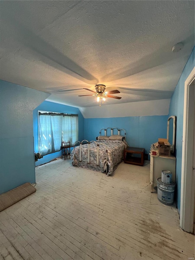 unfurnished bedroom with wood-type flooring, a textured ceiling, and ceiling fan