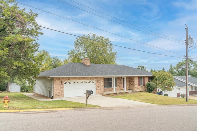 single story home featuring a storage unit and a front lawn