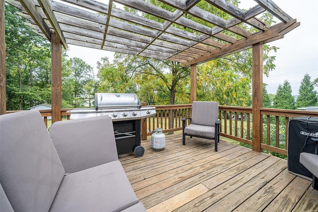 wooden deck featuring a grill, an outdoor kitchen, and a pergola