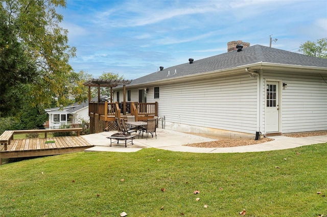 back of property featuring a patio area, a yard, and a wooden deck