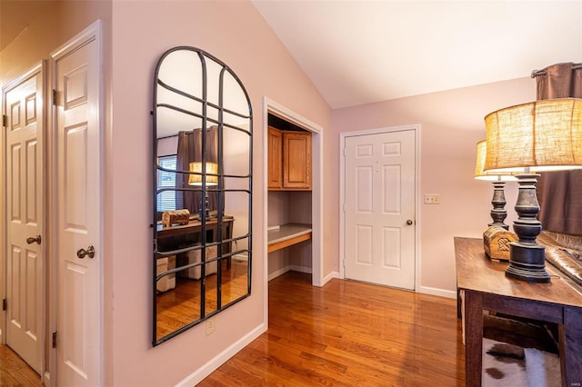 interior space featuring light hardwood / wood-style flooring and vaulted ceiling