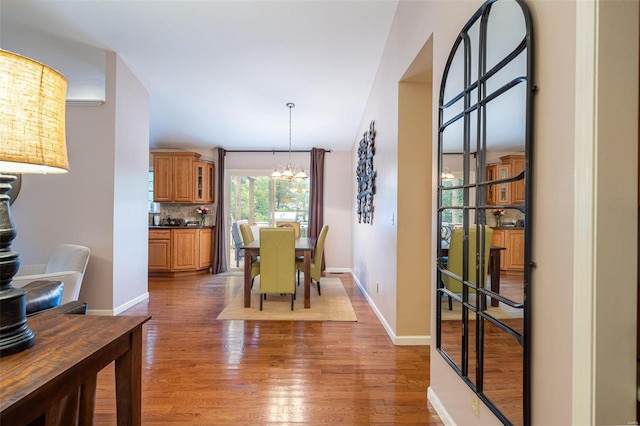 dining room featuring dark wood-type flooring and a chandelier