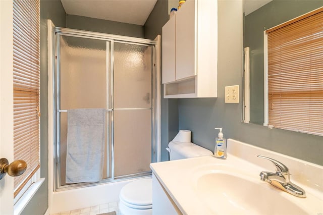 bathroom with vanity, toilet, and an enclosed shower