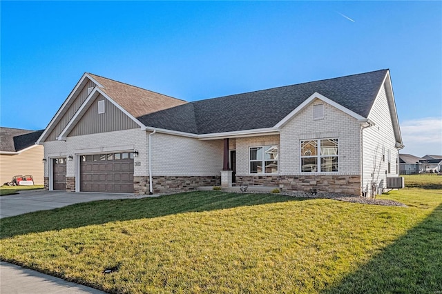 view of front of house featuring central AC unit, a garage, and a front lawn